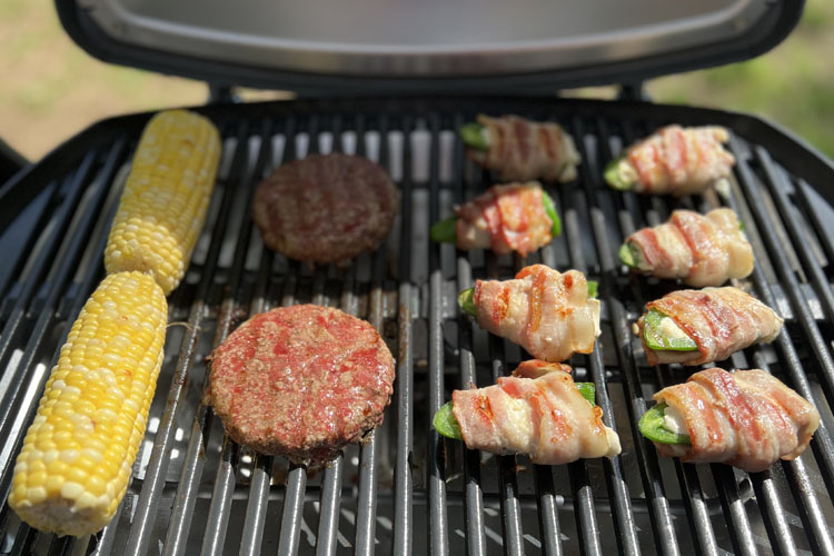 corn, burgers, jalapeno poppers cooked on the grill