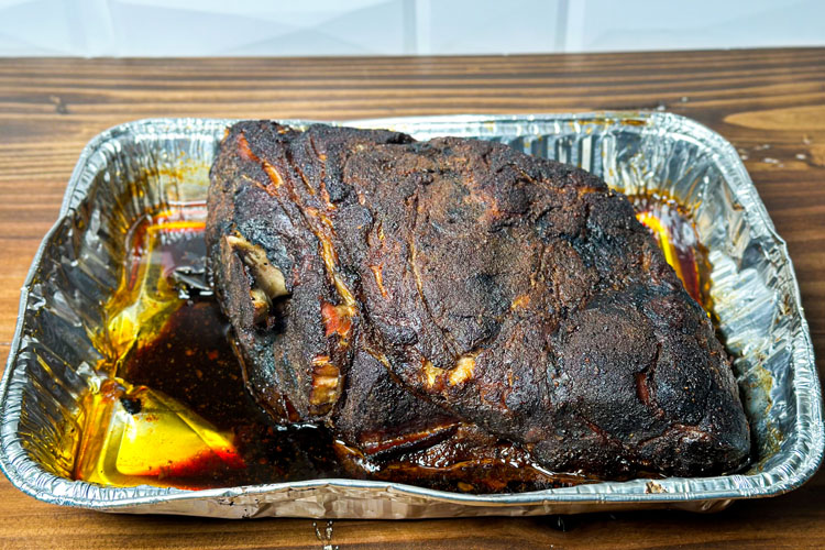 cooked pork butt from the electric smoker in a foil tray