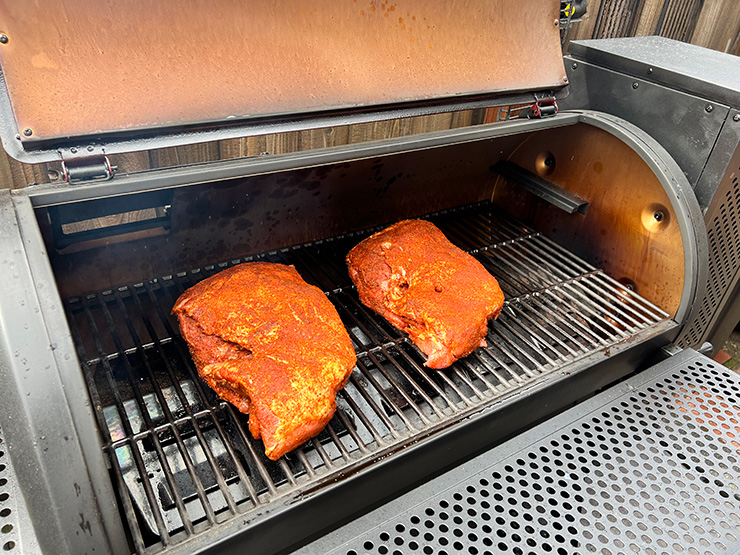 two pork butts smoking on the Char-Griller Gravity 980 grill