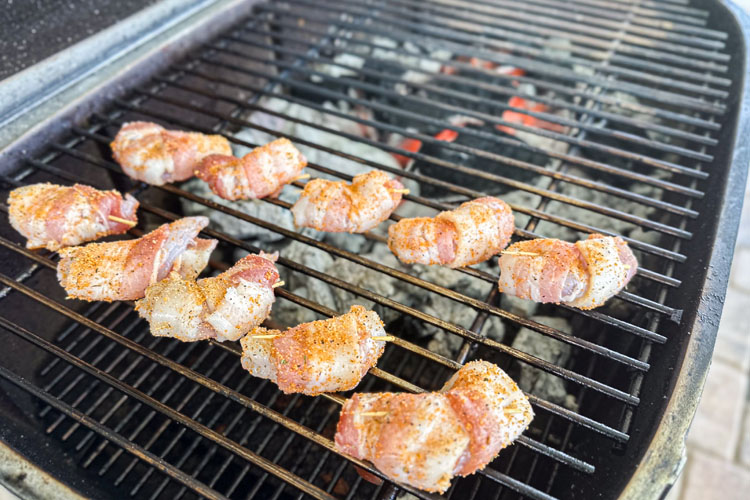 raw bacon wrapped shrimp on the grill