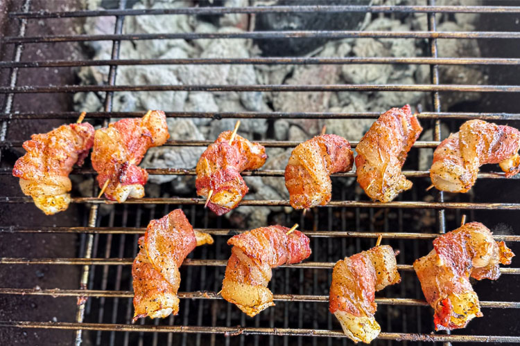 cooked bacon wrapped shrimp on the grill