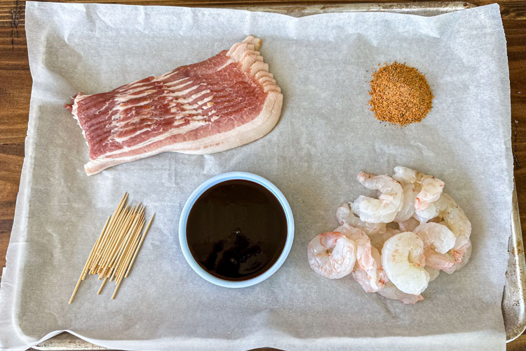 bacon wrapped shrimp ingredients laid out on white paper