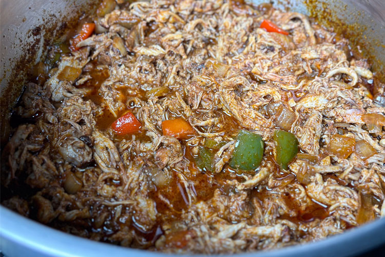 leftover pulled pork chili in a pot midway through cook