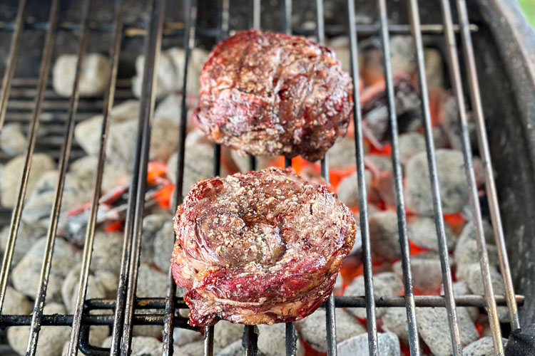 ribeye cap being seared over hot charcoal