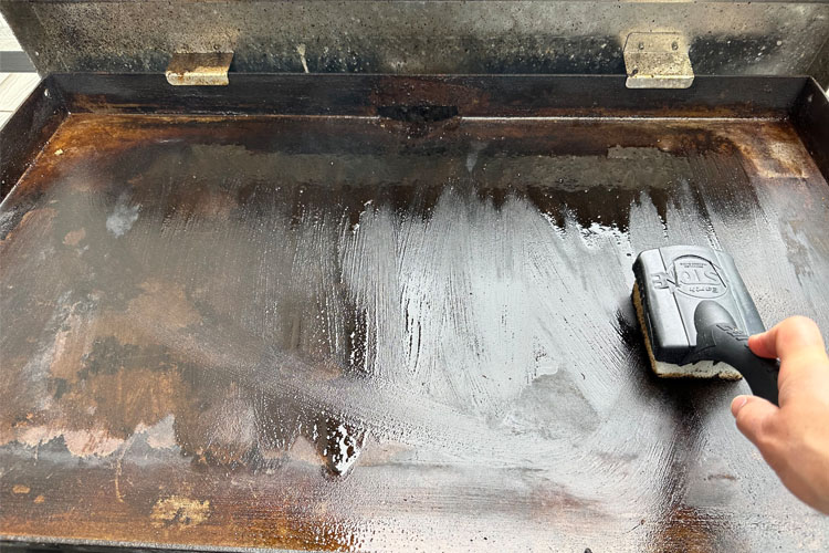 a griddle stone cleaning a oiled griddle