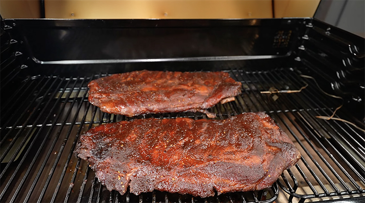 two slabs of pork ribs on Traeger Ironwood XL pellet grill