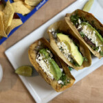 smashburger tacos on platter with corn chips