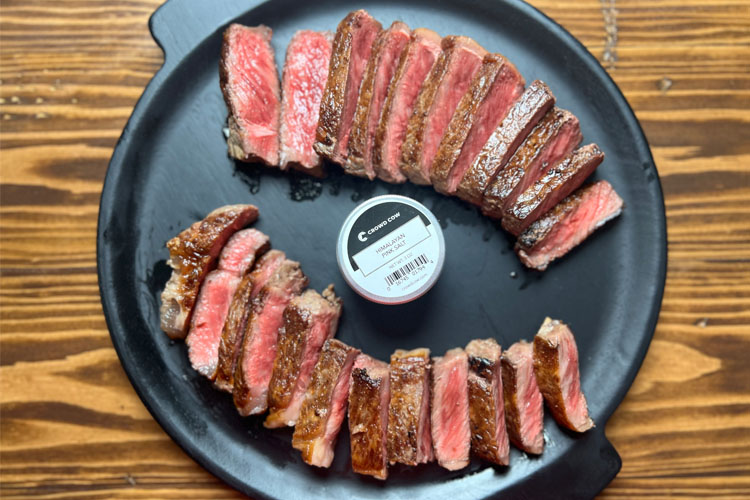 wagyu sliced with a jar of crowd cow salt in the middle