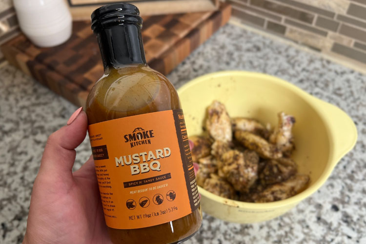 smoke kitchen mustard bbq sauce with bowl of wings in the background