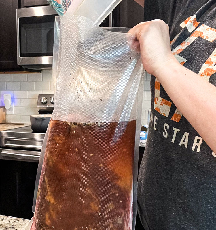 large plastic bag with brine being poured into it