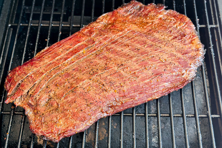 cooked flank steak on the grill