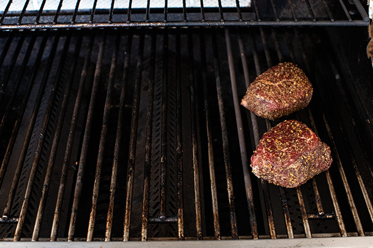 raw top sirloin steak on the grill