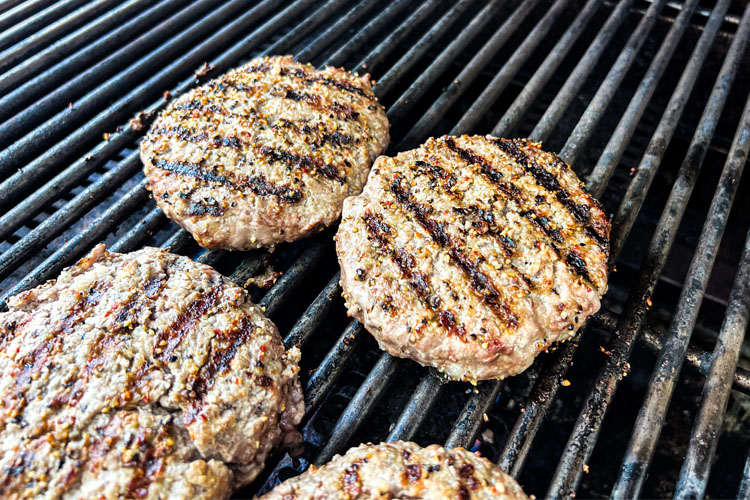 cooked tri tip burger patties on the grill