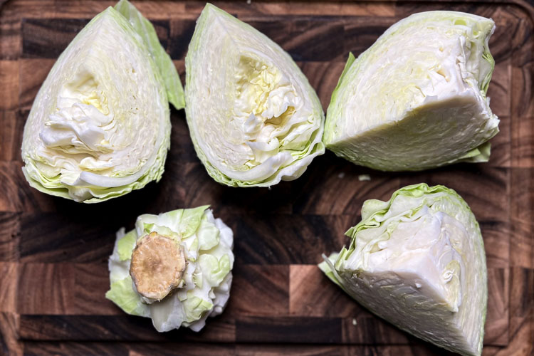raw cabbage on a wooden chopping board