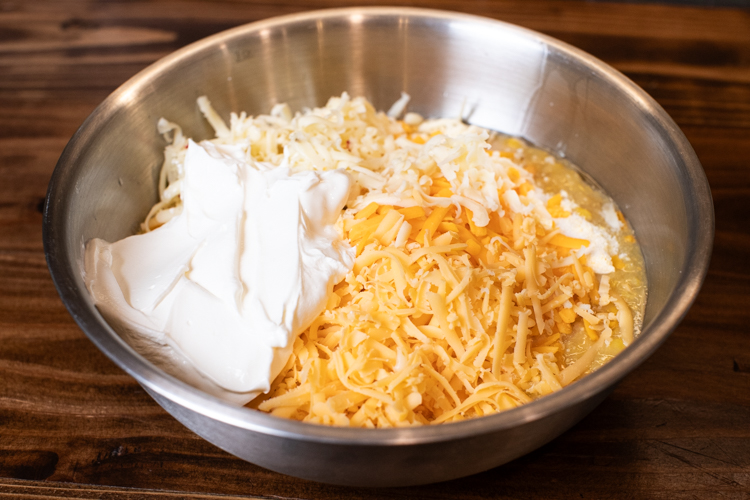 three cheese pudding ingredients in a metal bowl