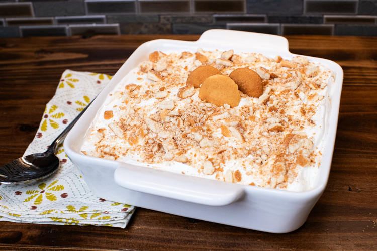 a baking dish with banana pudding decorated with crushed and whole nilla wafers