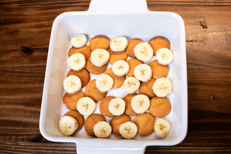 a baking dish with a layer of banana and nilla wafers in it