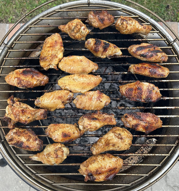 cooked pickleback wings on a charcoal grill