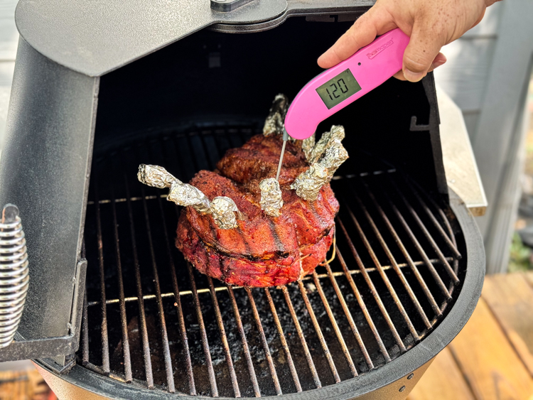 instant read thermometer stuck in the middle of crown of pork