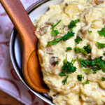 smoked garlic mashed potatoes plated with a wooden serving spoon