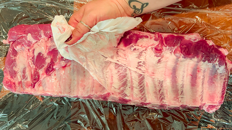 membrane being pulled from pork rib