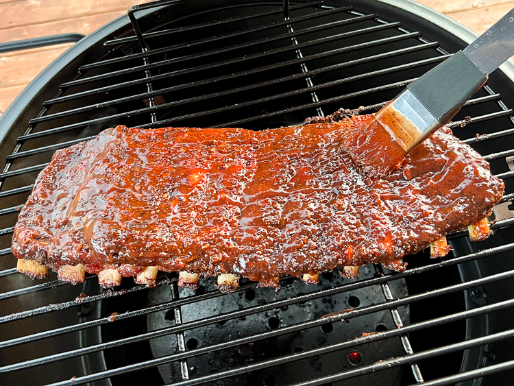 ribs on the smoker being glazed