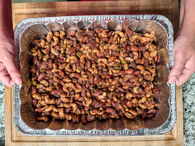 uncooked candied nuts in a metal tray