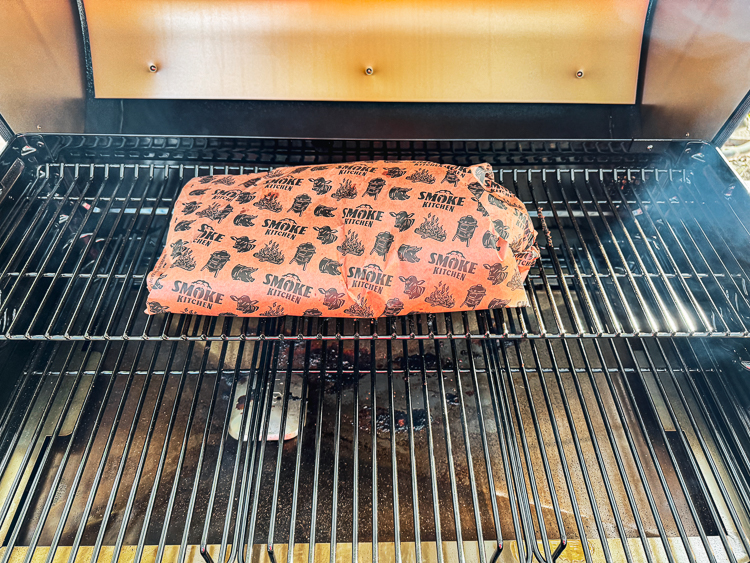 costco brisket wrapped in smoke kitchen pink butchers paper on the smoker