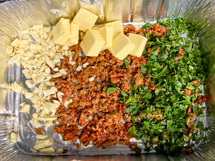 garlic, chorizo, butter and parsley in a aluminum tray