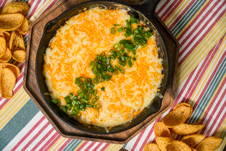 chili cheese dip with green onions on top