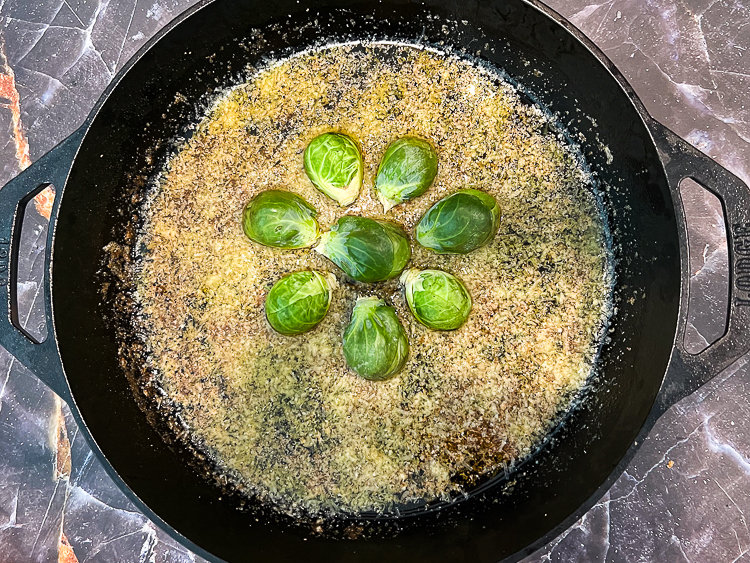 seven brussels sprouts in a cast iron pan
