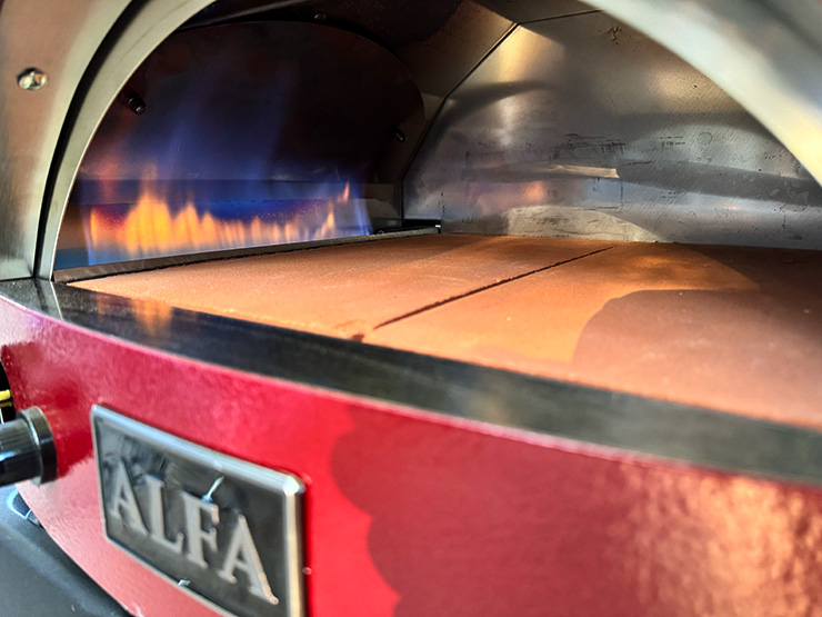 fire burning inside the alfa forni moderno pizza oven