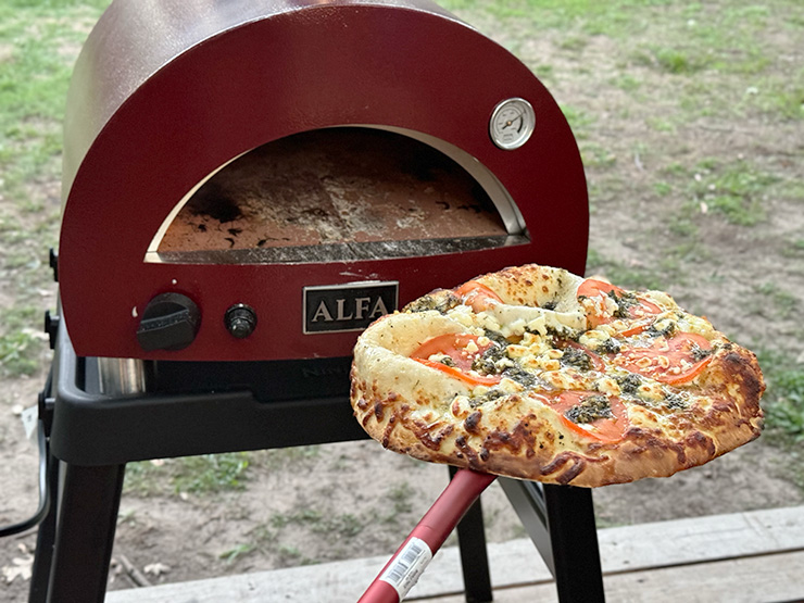 pizza on a pizza peel near the alfa forni moderno pizza oven