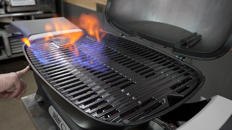 a person pushed the ignition button to light up the Weber Q+ Gas Grill