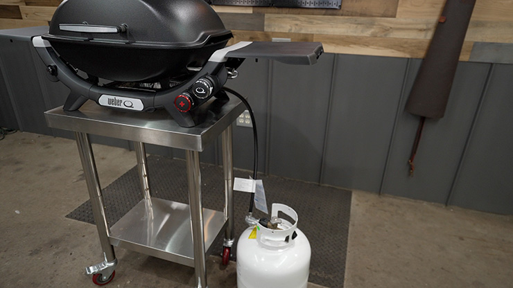 Weber Q 2800N+ gas grill hooked to a propane tank