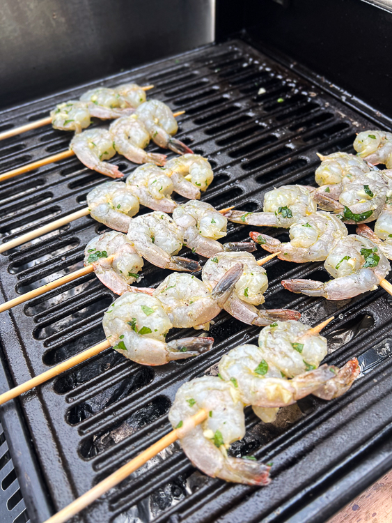 raw skewered shrimp on the grill