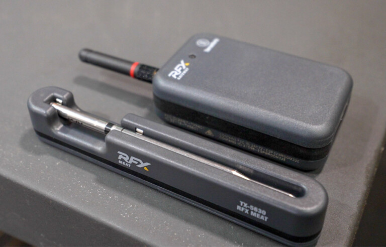 thermoworks rfx probe in its charger next to the receiver.