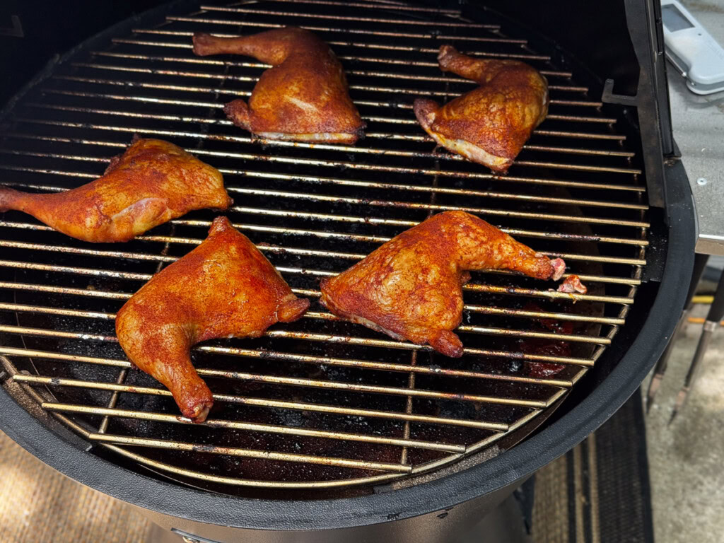 cooked chicken quarters on the grilla grill pellet smoker