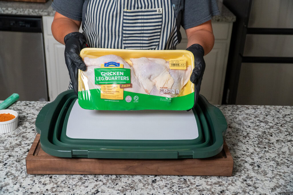 a supermarket tray of raw chicken quarters