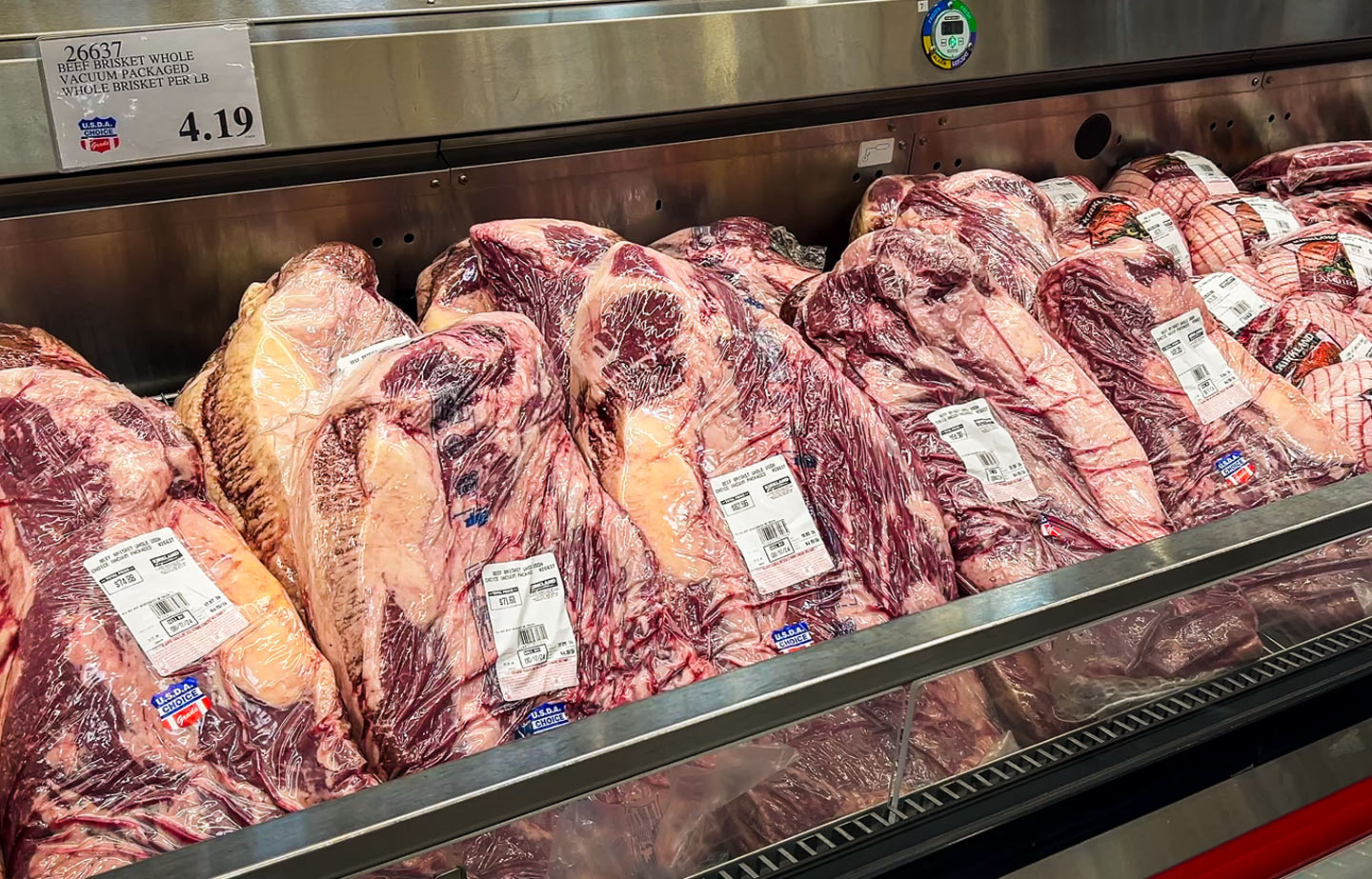 USDA whole briskets in the Costco meat case with price sign visible